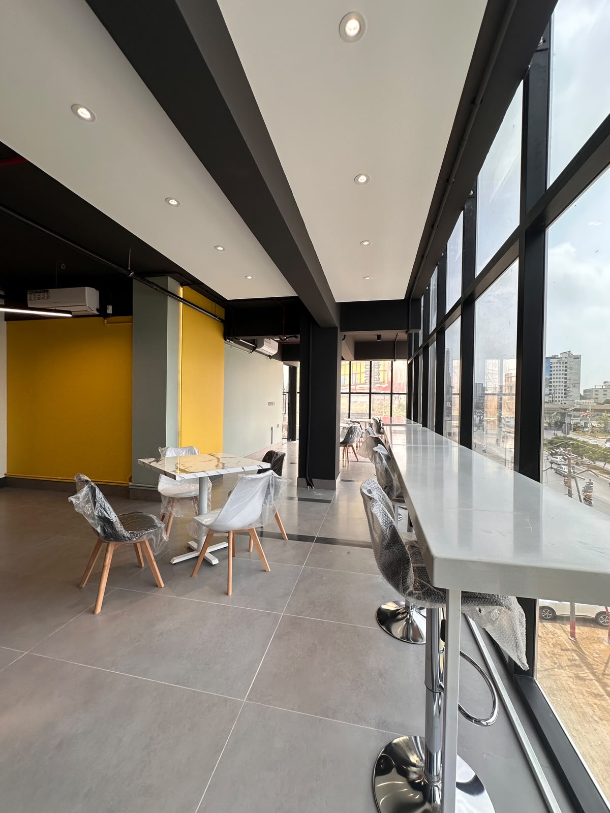 Bright lounge corridor with casual seating at WorkMore, The Pavilion Karachi