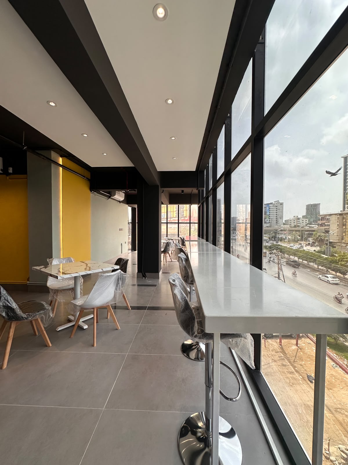 Window counter workspace overlooking Shahrah-e-Faisal at WorkMore, The Pavilion