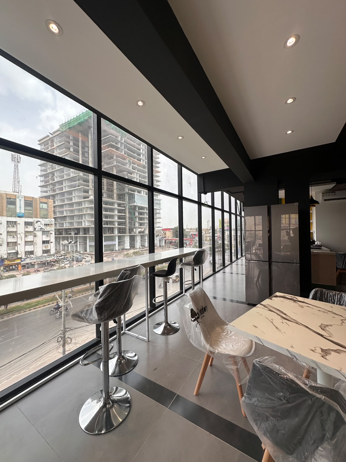 High-top window bar seating with city views at WorkMore, The Pavilion